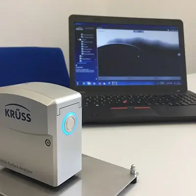 Contact angle test to determine the ability of a fluid to wet a surface